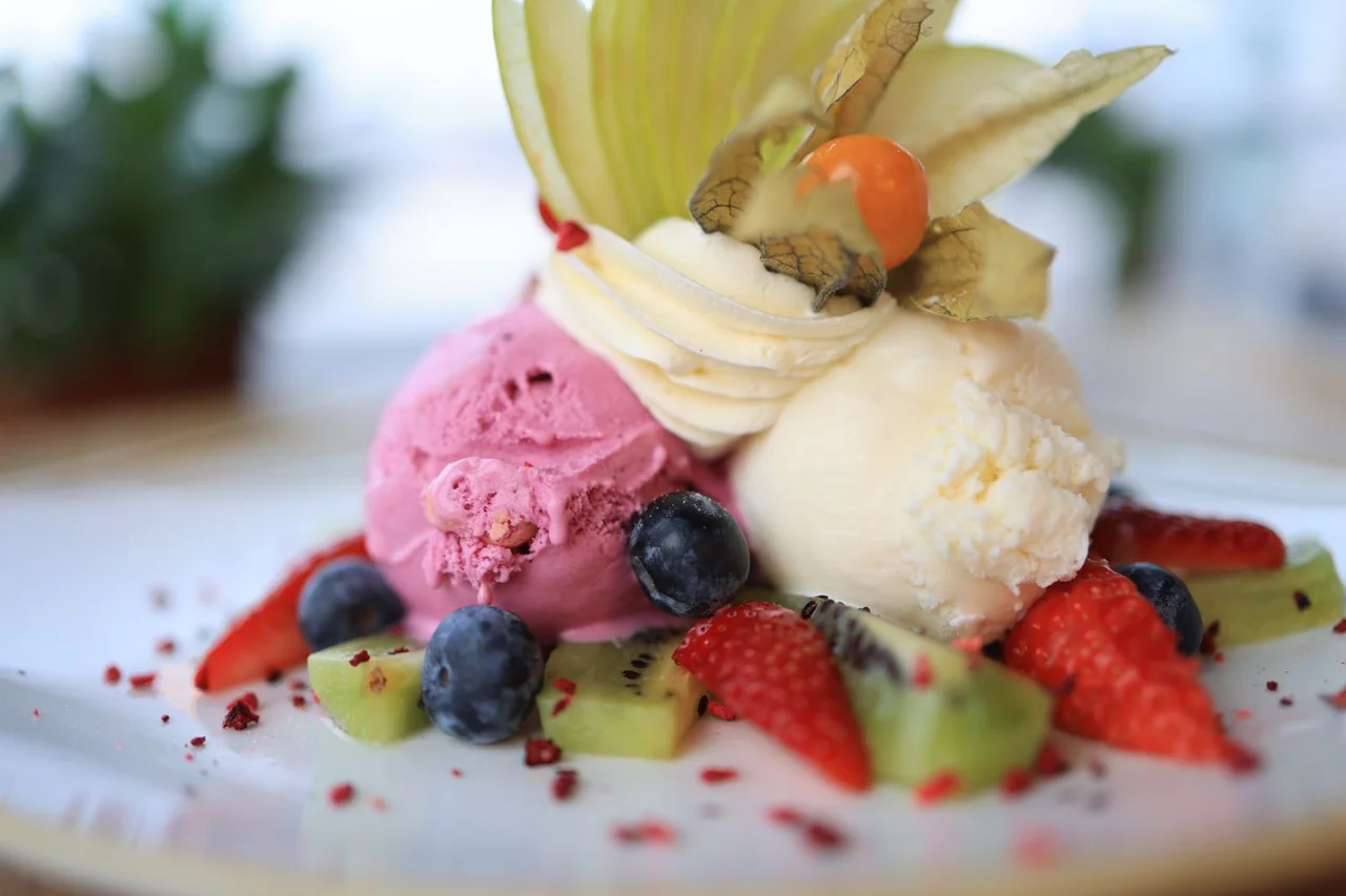 Fresh Belgian waffle served with scoops of artisan ice cream and summer berries