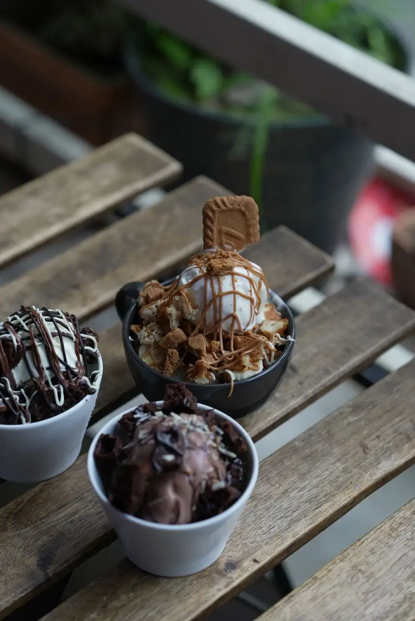 Seasonal ice cream assortment arranged on outdoor wooden café table