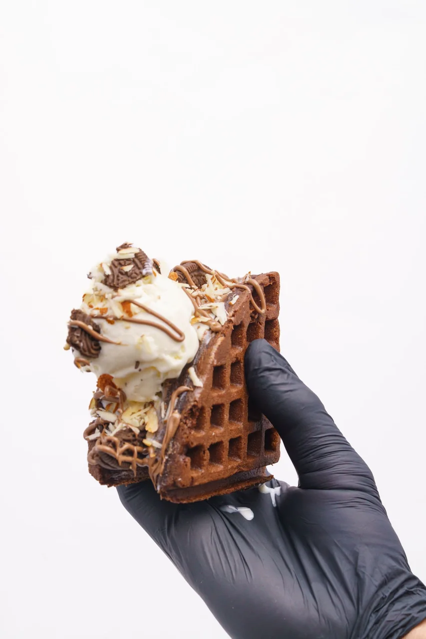 Handcrafted waffle ice cream sandwich with dark chocolate drizzle