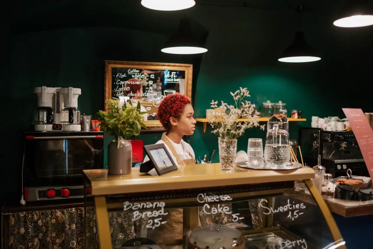 Barista and café staff providing courteous service at the dessert counter